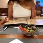 Visible pokies in a restaurant wearing a one shoulder top