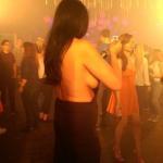 Mimi wearing a sideboob halter dress in a club