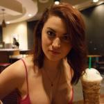 Ecstatic redhead at hotel cafe: beautiful cleavage in red tank top