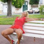 Pantyless cougar in red dress and heels on park bench