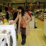 Raven wife wearing coat stockings and boots at supermarket