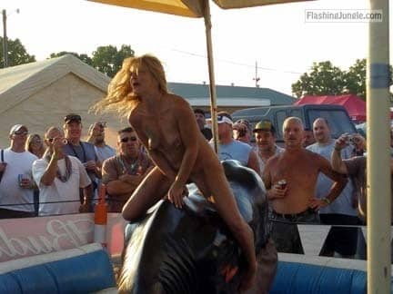 Naked MILF blonde riding bull public nudity