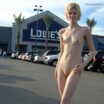 Skinny naked blonde in front of Lowe’s warehouse