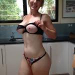 Lonely naughty mom in exotic lingerie in the kitchen