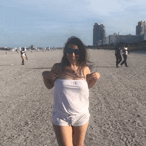 Flashing GIFS - Round perky tits flash on beach