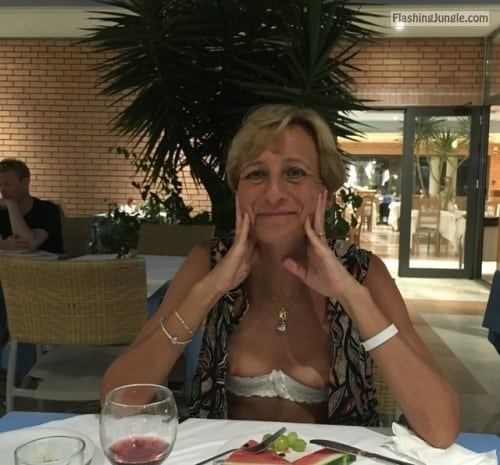 Public Flashing Pics - Slim blonde mature wife boobs out at hotel restaurant