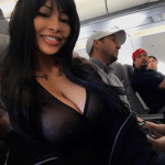 Deep cleavage – pale black bimbo in airplane