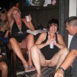 Two pantieless mature flashing slags at a bar drinking