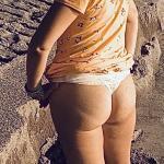 My wife wearing a see-through dress showing her ass at the beach