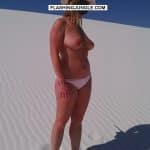 Sexy busty MILF topless in sand