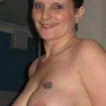 Mature whore gets her tits out