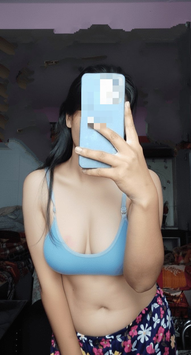 Real Amateurs : A young woman's private moment is captured as she inadvertently exposes herself while using her smartphone, revealing her breasts in a softly lit room. Caught in the Act: Asian Beauty Flashes Her Boobs on Camera