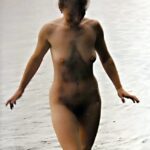 Beach Flash: Nude Stroll in Shallow Waters
