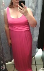 Flashing Store Pics: Mirrored Desire: A Bathroom Confession A woman in a pink dress takes a mirror selfie in a bathroom, capturing her reflection and the shower behind her, sharing a moment of intimate vulnerability.