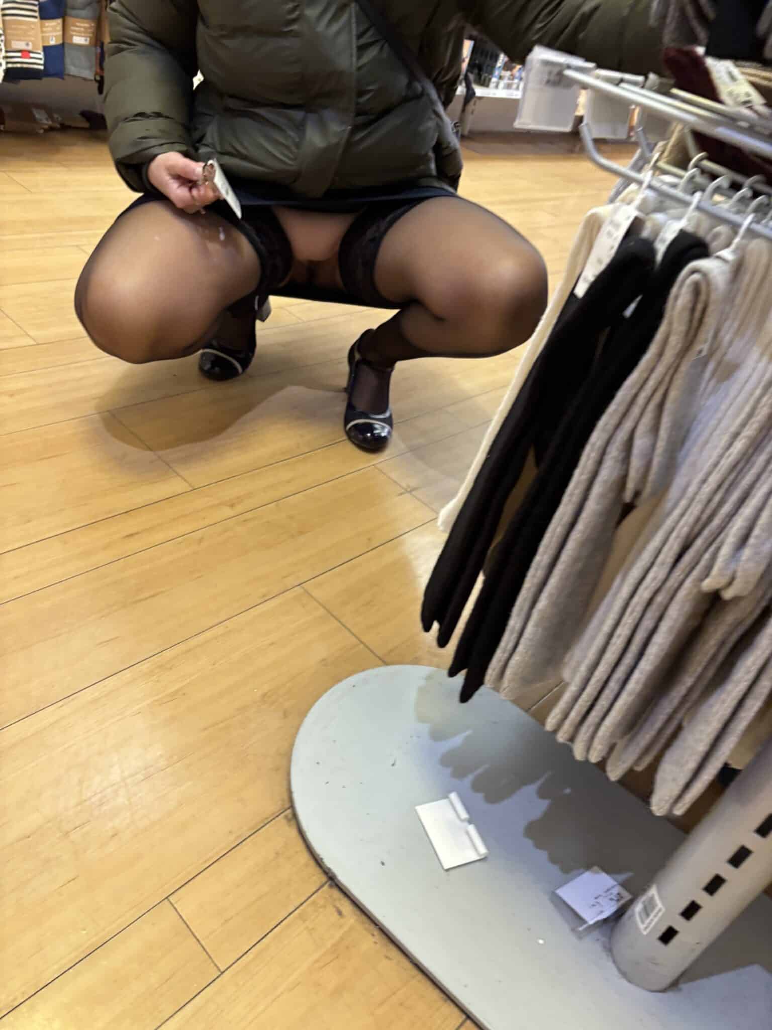 twerking naked in store - Thigh-High Tease: Retail Rendezvous A woman in a retail store's hosiery section stands with legs apart, her black lace thong pulled aside, exposing her shaved pussy and round ass. She wears she... - Bitch Flashing Pics