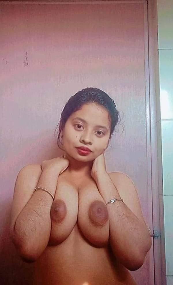 milf cleavage - Who’s the MILF Flashing Her Massive Boobs in the Bathroom? A MILF confidently flashes her large breasts in an intimate bathroom setting, arms raised to frame her cleavage, wearing only bracelets. - Bitch Flashing Pics