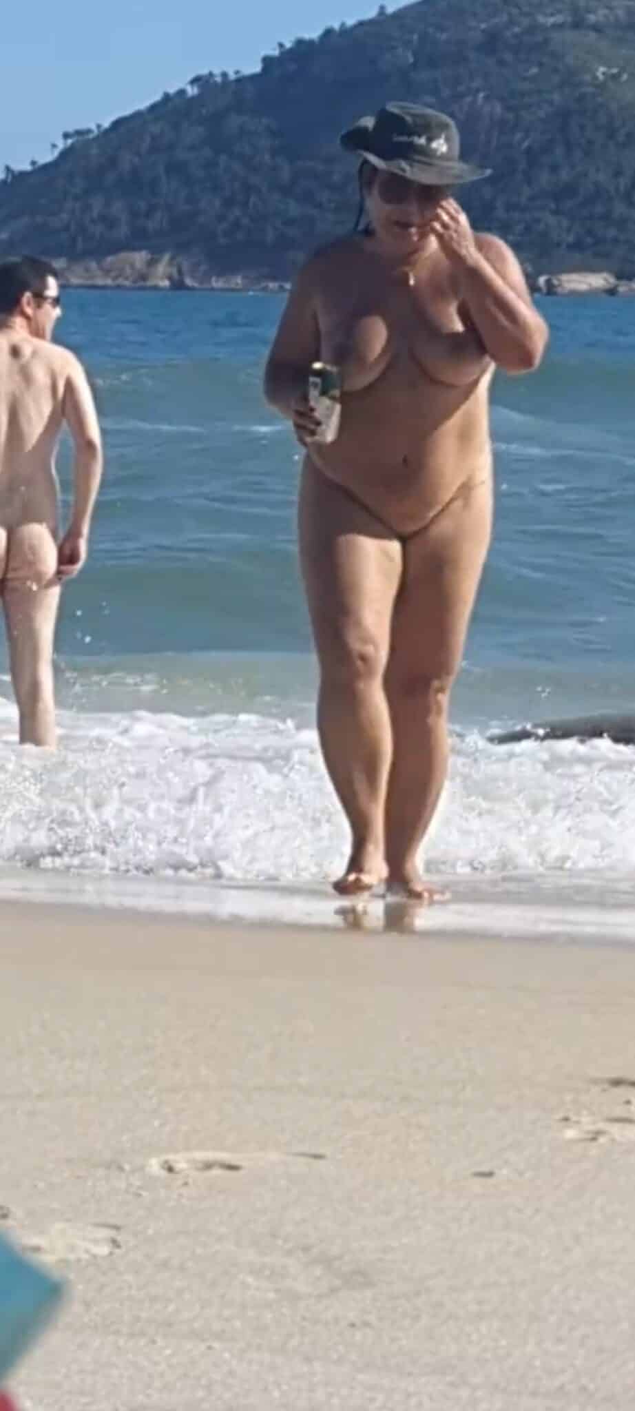 fromerome com candid nude - MILF Flashes Her Assets at Nude Beach A MILF confidently displays her nude body at a public beach, showcasing her large breasts and hairy pussy. The scene captures raw, unapologetic nudity. - Bitch Flashing Pics