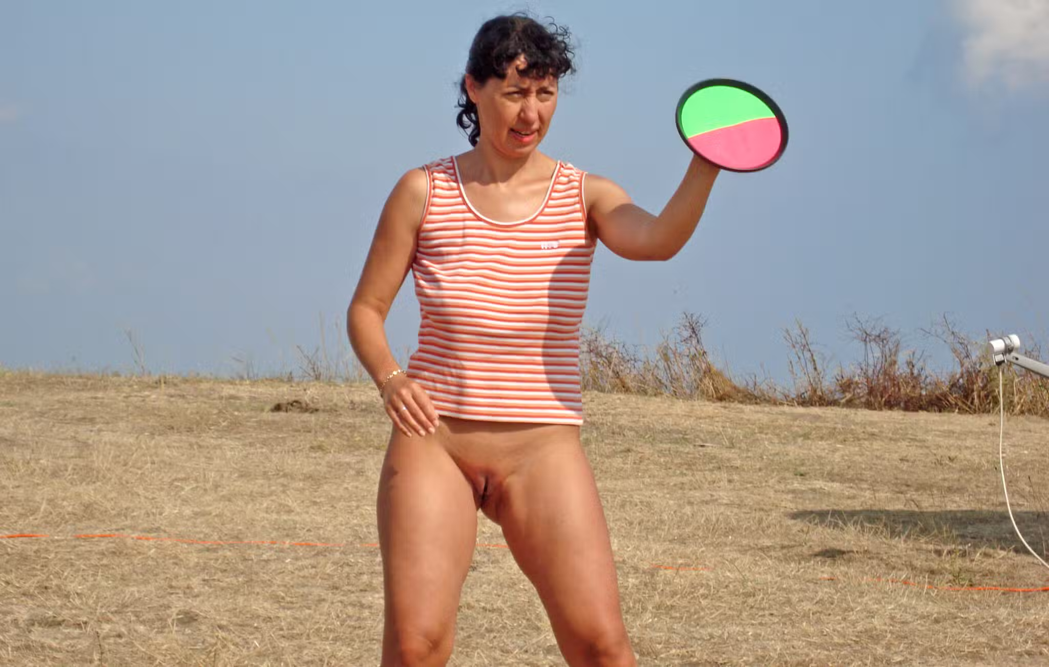 ftv public nude caught - MILF Flashes Hairy Pussy in Public MILF stands bare-assed in a field, pussy exposed, holding a disc. No pants, no underwear, just natural and defiant. - Bitch Flashing Pics