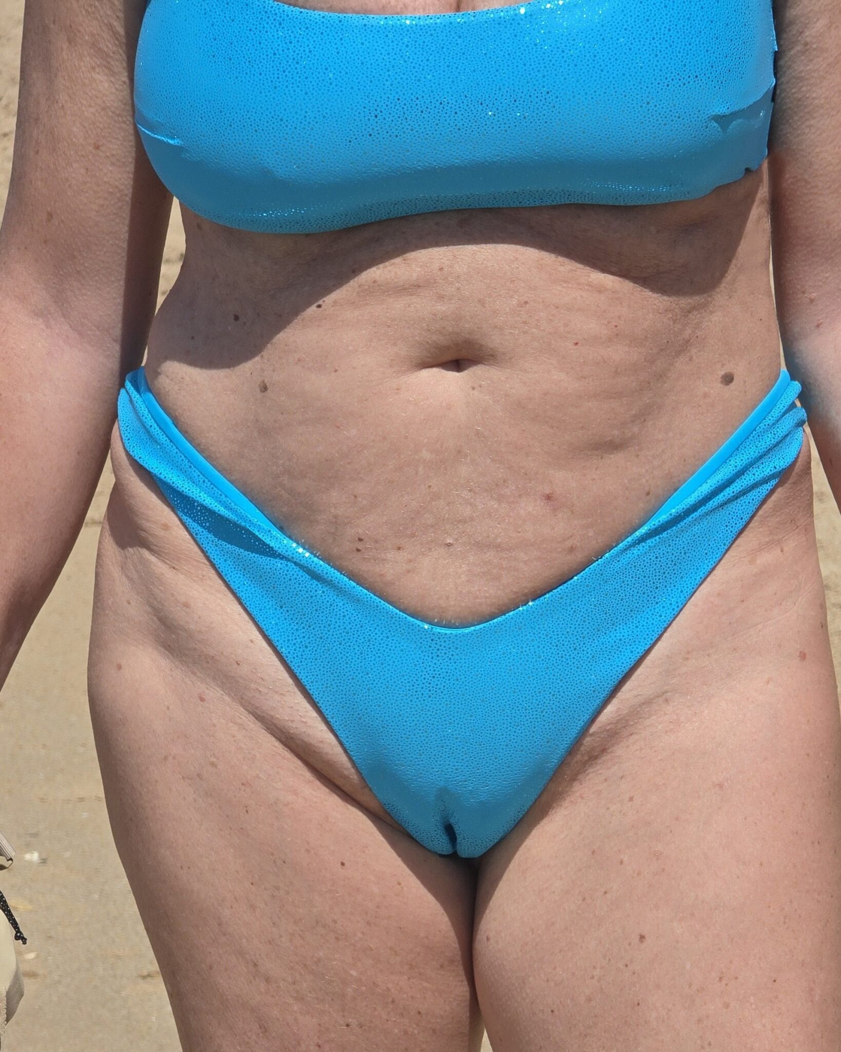 kaduna bitch hip and bombom picture - Malene’s Beach Bikini Tease: Camel Toe Reveal Malene wears a bright blue bikini bottom, exposing her upper pubic mound and hip bones on a sandy beach. The snug fit reveals trimmed pubic hair, hinting at ... - Bitch Flashing Pics