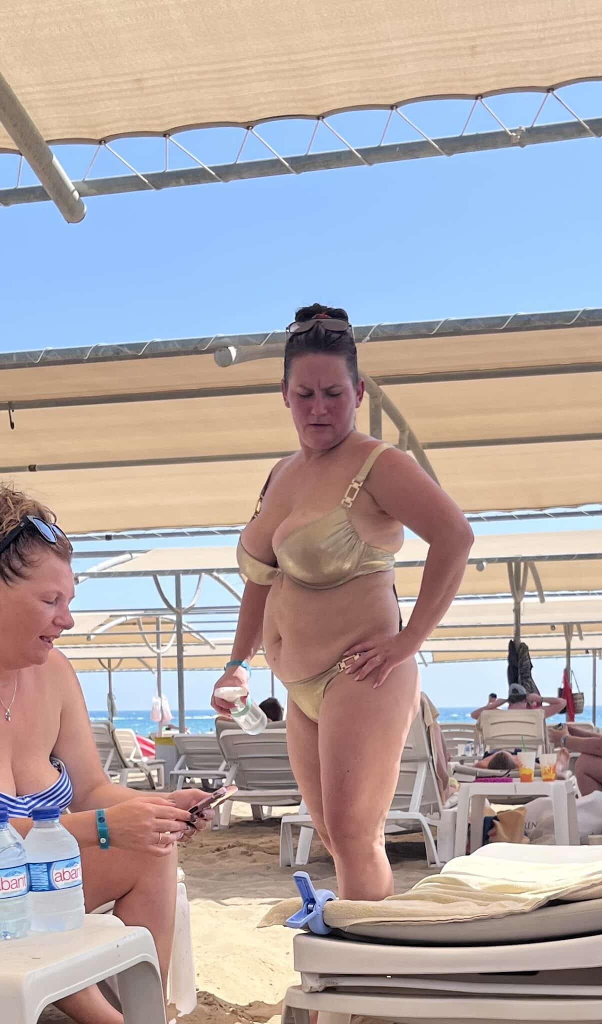 mallorca beach flash boobs - Beach Bikini Boobs: MILF Flashing in the Sun A MILF flashes her assets in a gold metallic bikini at the beach, drawing attention with her large, saggy tits spilling out of her top. Her companion, a slim... - Boobs Flash Pics