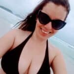 Who’s the Beach Babe Flashing Her Cleavage?